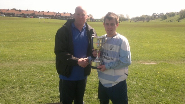 Lee Marsh captain of The Inn Place recieving 2nd Division winners Trophy